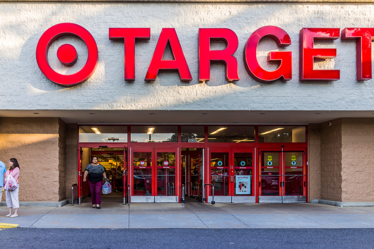 arget store entrance with woman walking out with sign