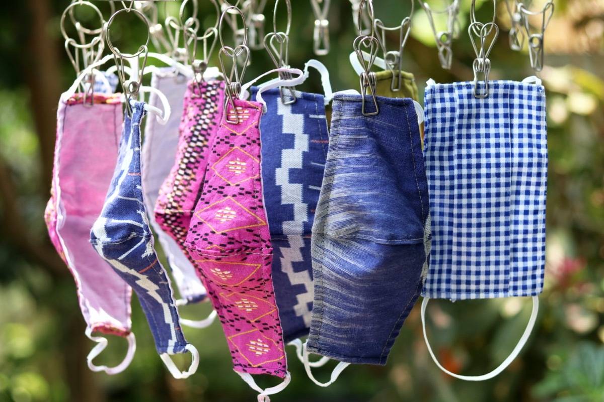 cloth face masks drying on clothesline amid coronavirus pandemic