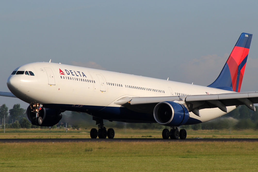 A Delta plane landing at an airport