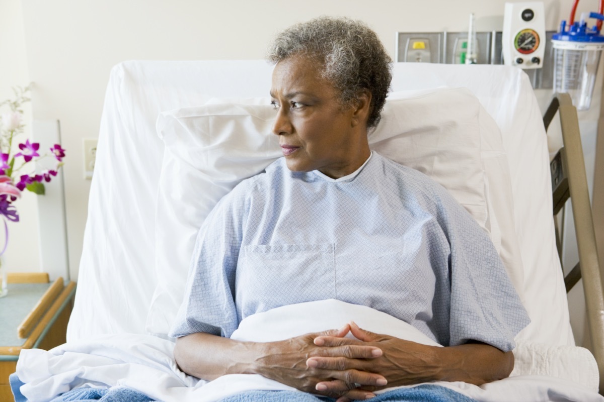 Senior black woman sitting in hospital bed