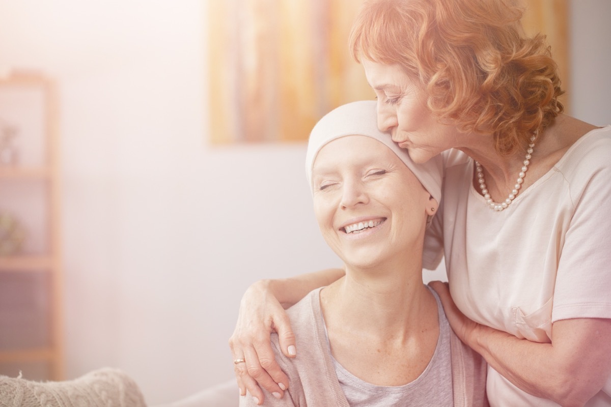 Friend comforting woman with cancer