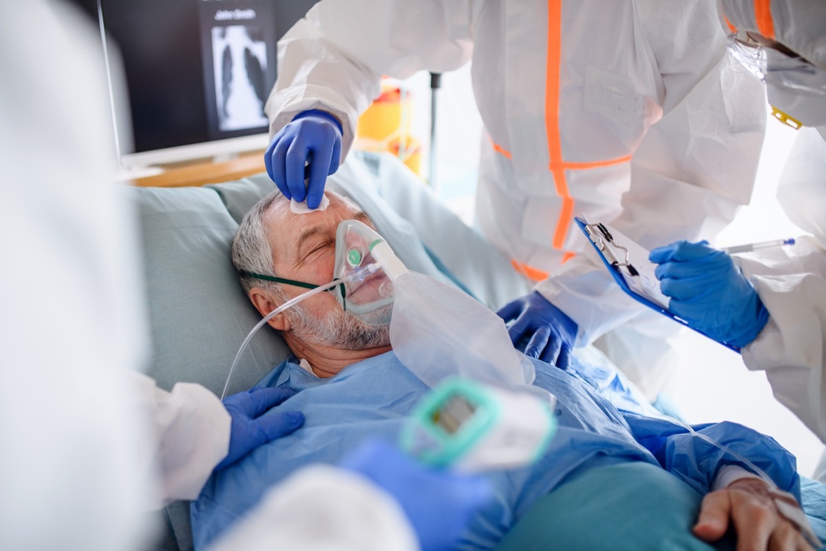 An infected patient in quarantine lying in bed in hospital, coronavirus concept.