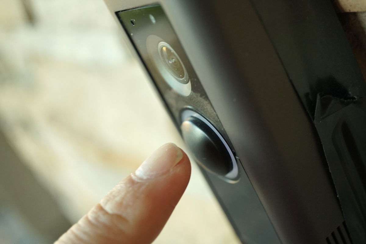 shot of hand pressing doorbell