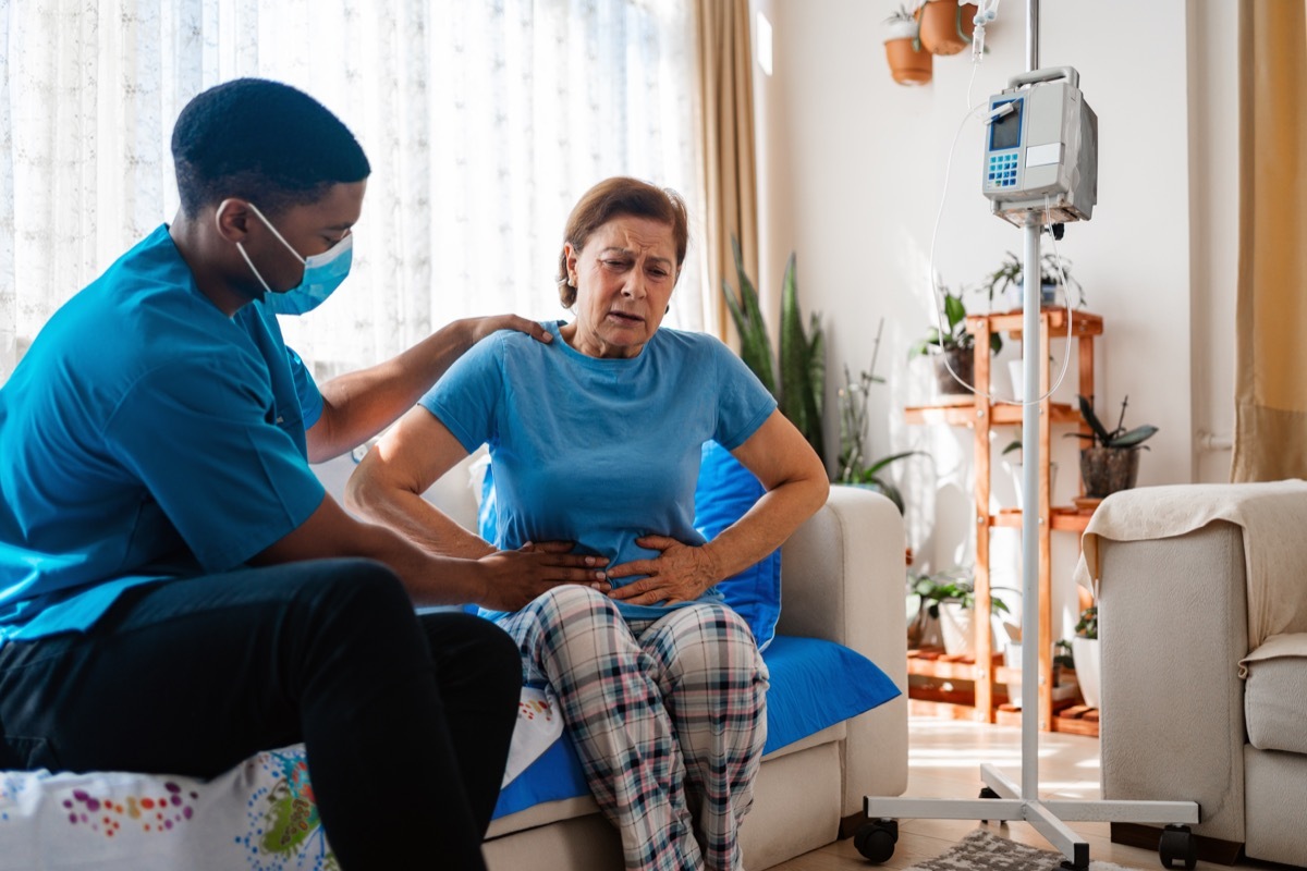 Abdominal pain patient woman having medical exam with doctor on illness from stomach cancer, irritable bowel syndrome, pelvic discomfort, Indigestion, Diarrhea, GERD (gastro-esophageal reflux disease)