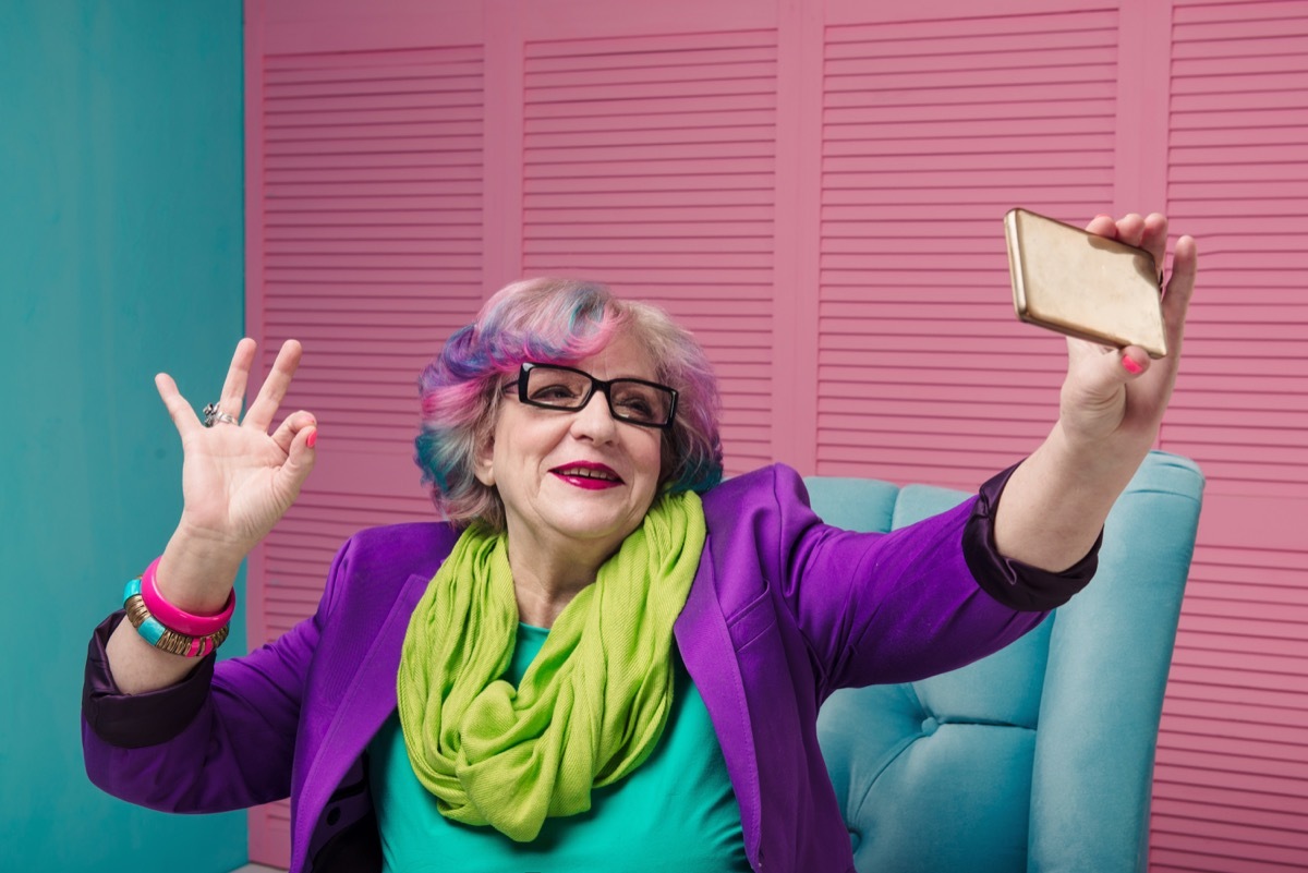 old woman with pink hair taking a selfie