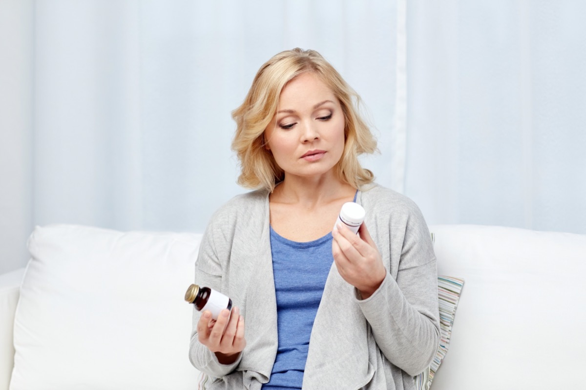 woman with medicine jars at home