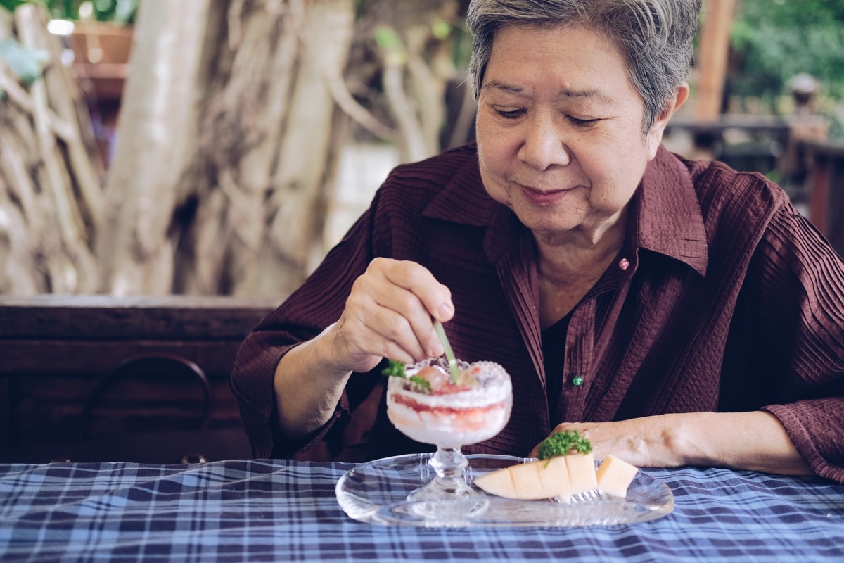 Older woman eating dessert