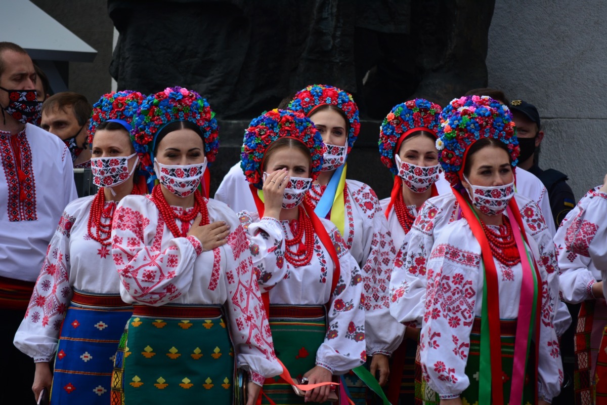 Members of a choir singing in face masks.