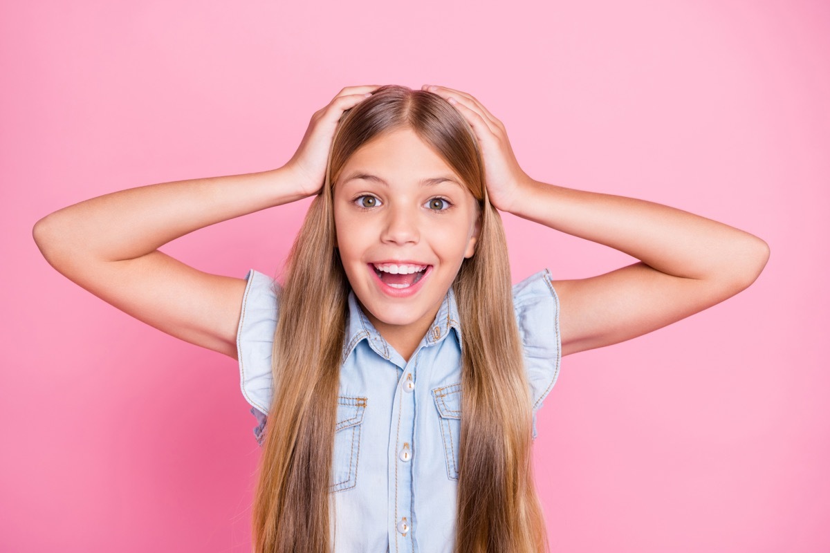 young girl scratching her head as she learns answers to science trivia questions