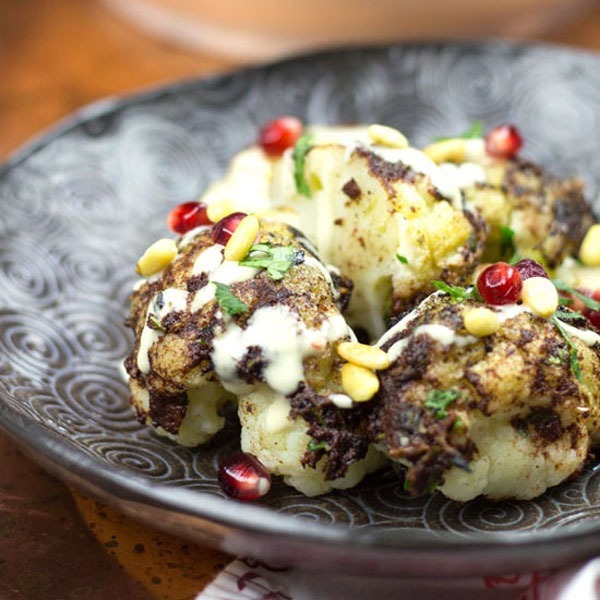 cauliflower shawarma with pomegranate, tahini, and pine nuts