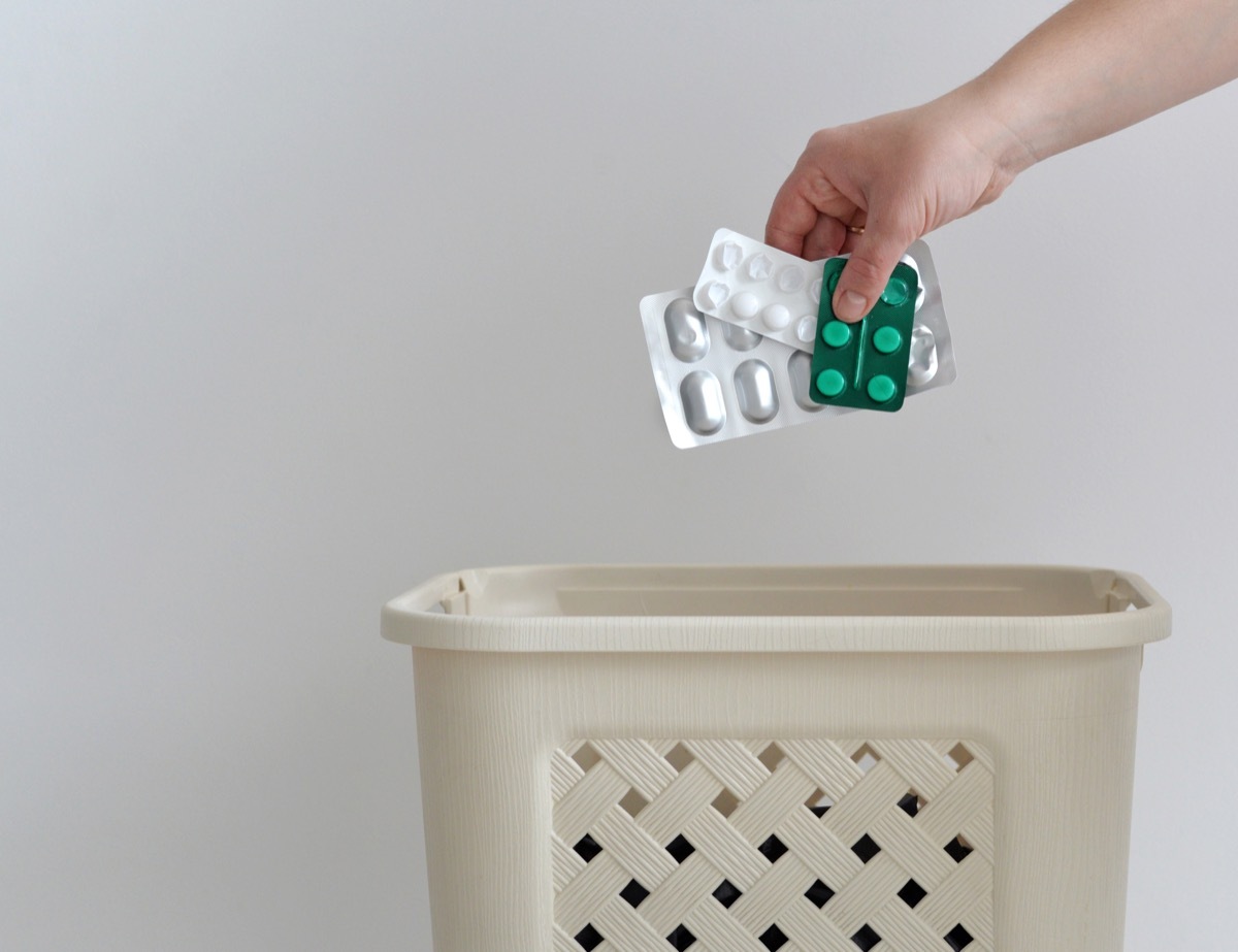 hand throwing pills away