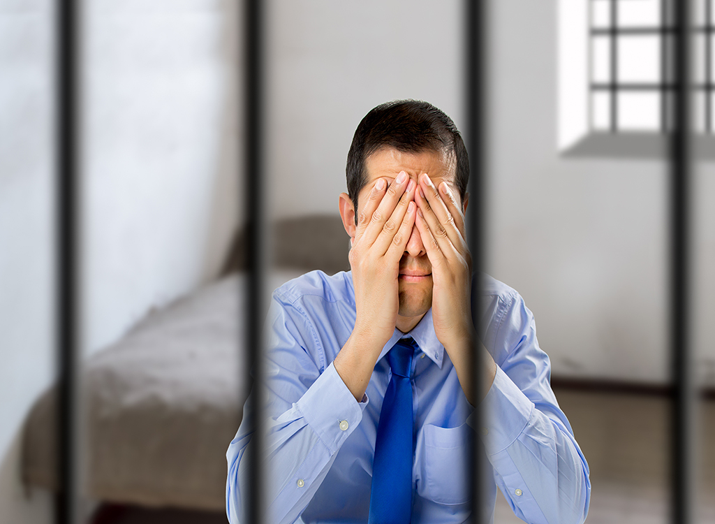 Man sitting in prison cell