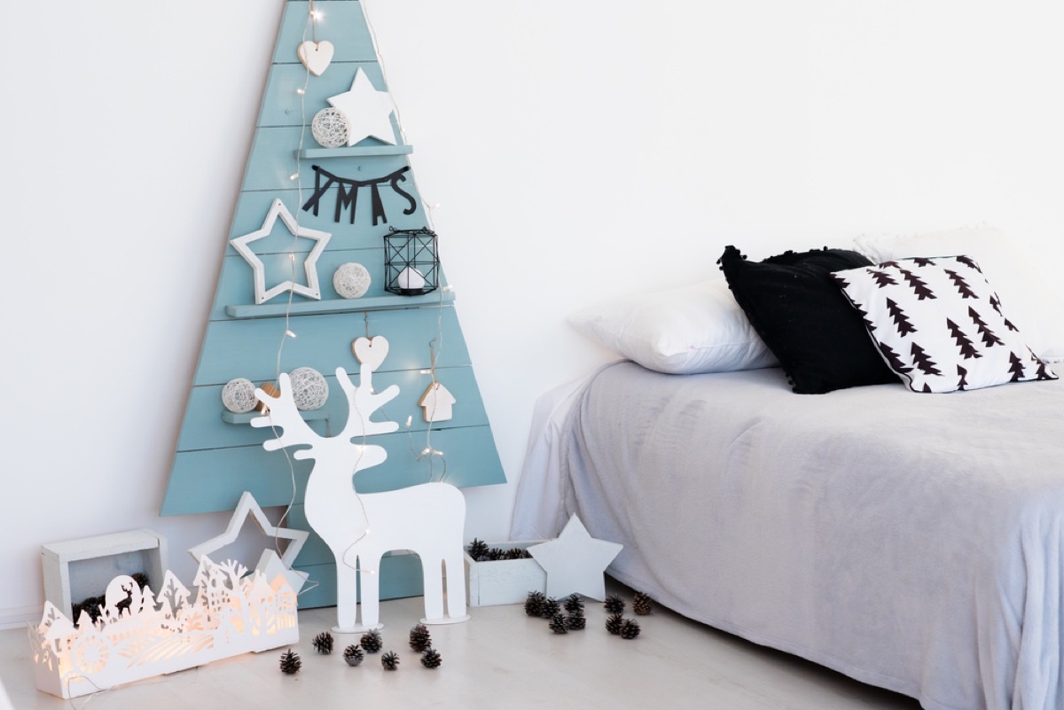 child's bedroom with blue wooden christmas tree