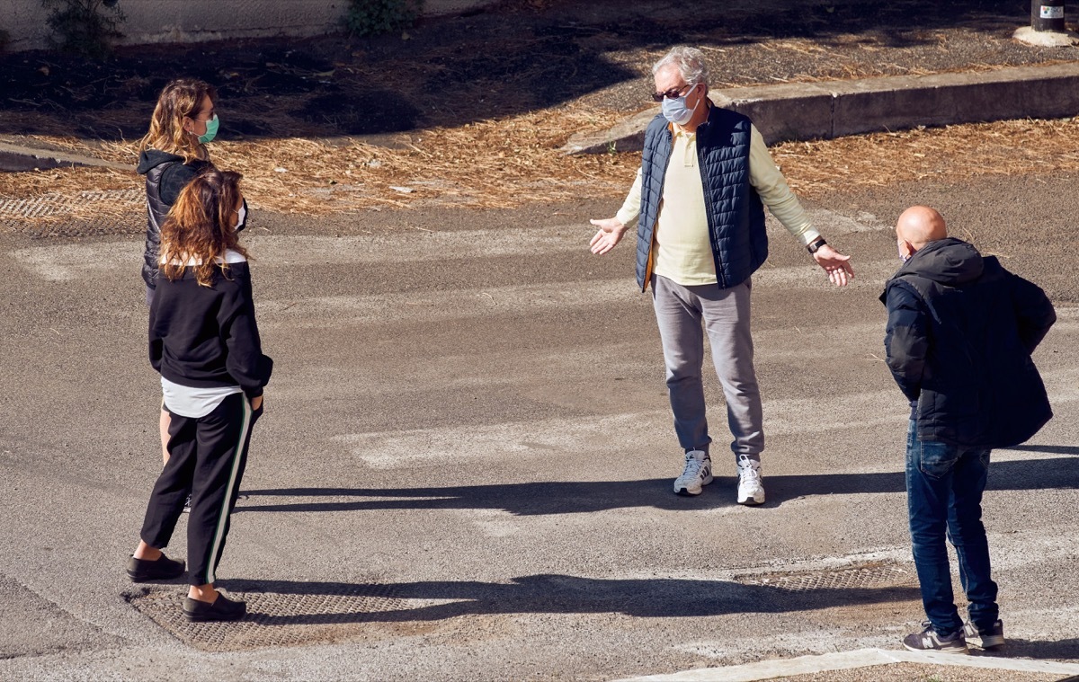 People wearing masks social distance hang out